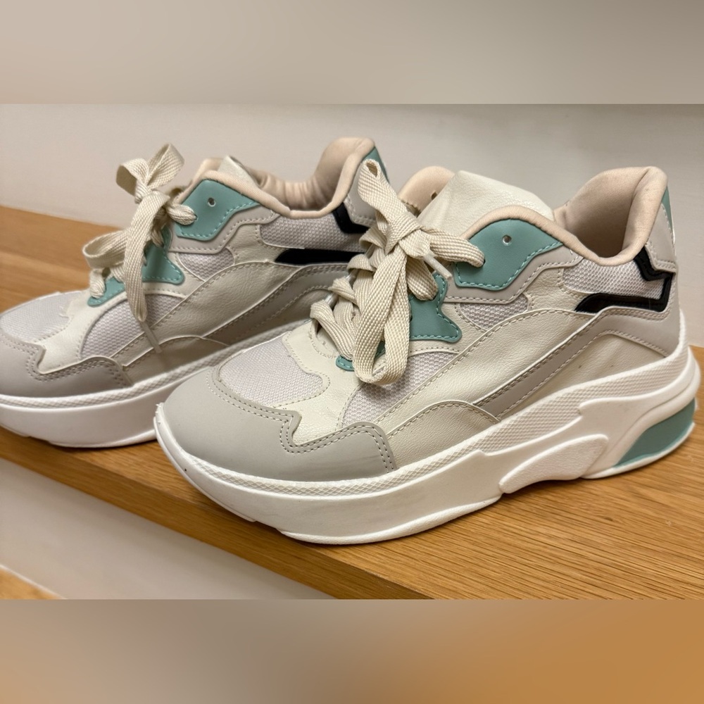 White and Green Sneakers with Chunky Sole and Breathable Materials.
